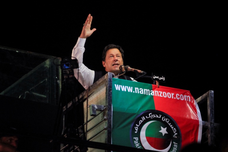 Ousted Pakistani Prime Minister Imran Khan gestures as he addresses supporters during a rally, in Lahore